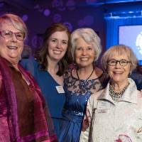Marcia Haas and Nancy Lubbers posing with guests at Enrichment.